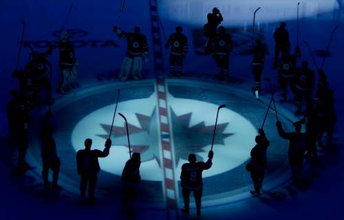 Winnipeg Jets players raise their sticks as they are introduced to the crowd prior to their inaugural game against the Montreal Canadiens at the MTS Centre in Winnipeg, Sunday, Oct. 9, 2011. THE CANADIAN PRESS/Jonathan Hayward