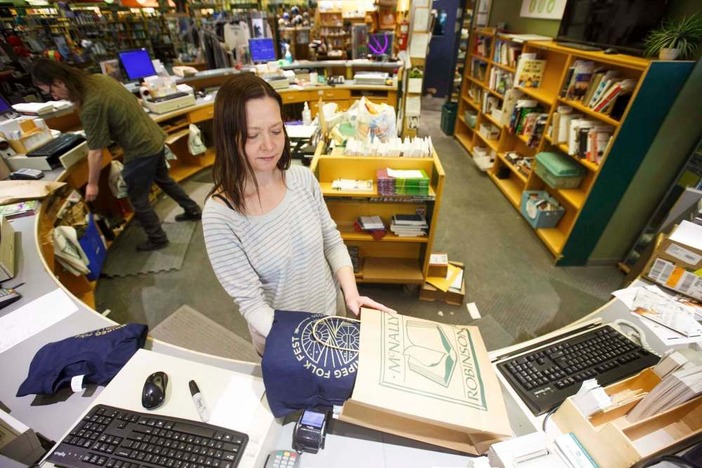 MIKE DEAL / WINNIPEG FREE PRESS
Angela Torgerson packages orders of Winnipeg Folk Festival sweaters.