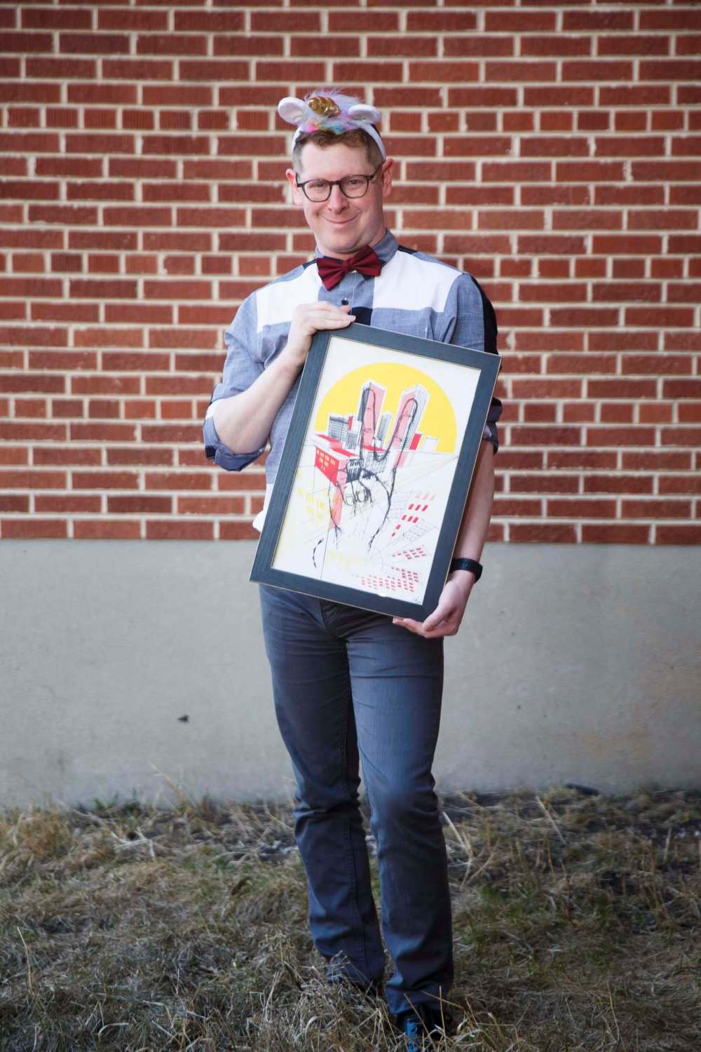 MIKE DEAL / WINNIPEG FREE PRESS
Ari Weinberg, Artistic Director of Winnipeg Jewish Theatre, wears his unicorn horn while holding some artwork he loves.
