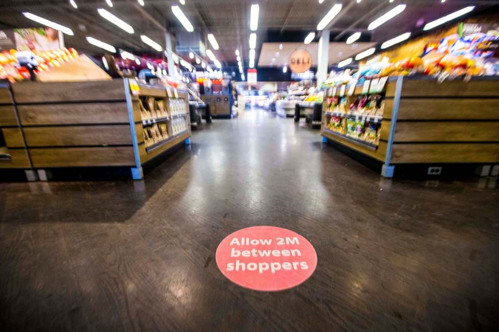 MIKAELA MACKENZIE / WINNIPEG FREE PRESS
Floor decals encourage social distancing at the Save-On Foods.