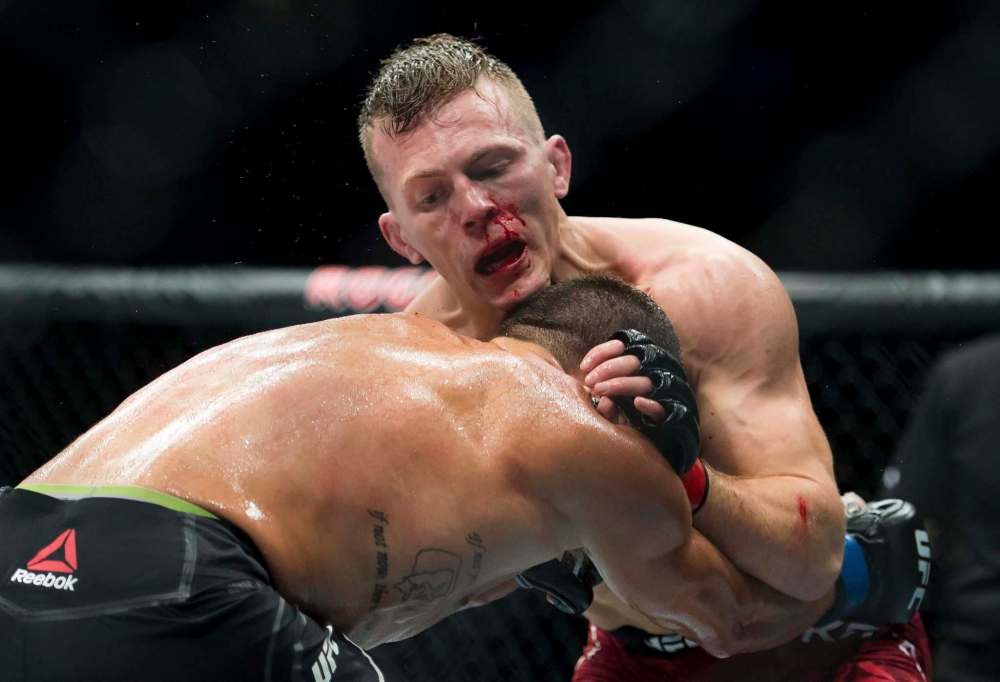 Jonathan Hayward / The Canadian Press files
Brad Katona (top) and Hunter Azure fight