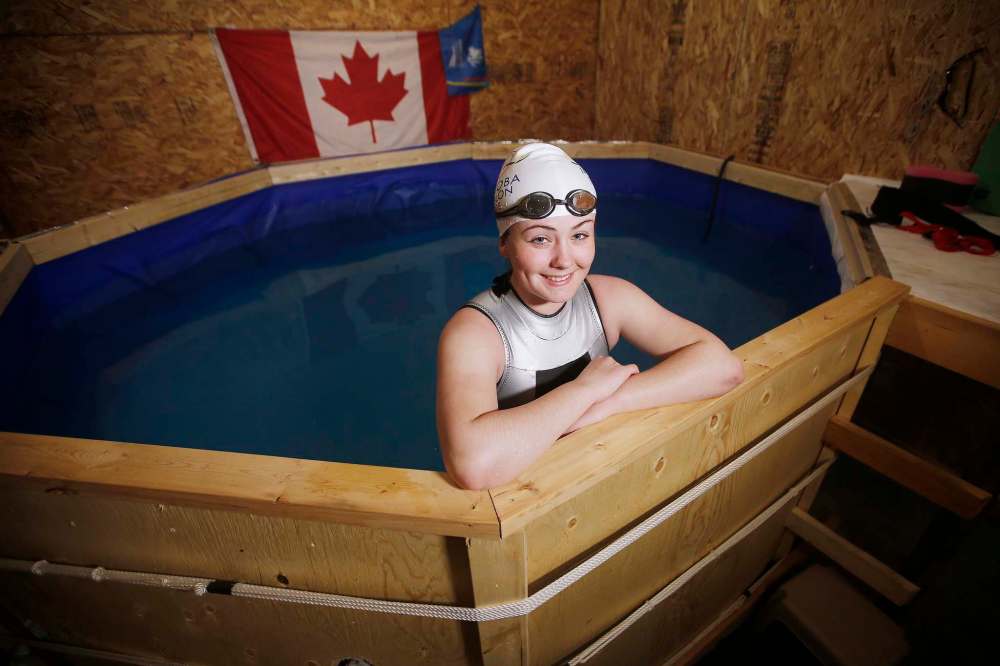 JOHN WOODS / WINNIPEG FREE PRESS
Triathlete Megan Van Heyst’s parents have rigged up a temporary lap pool, using a pool liner and some lumber, in their garage. She swims while tethered in place.