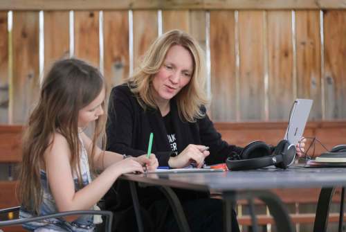 Teacher Cori Wiebe, with her daughter, Eva, 8, misses the social contact with students, but is finding online teaching is getting easier. (Ruth Bonneville / Winnipeg Free Press)