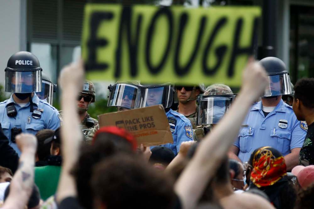 Matt Slocum / The Associated Press
Protesters rally Monday as police officers and Pennsylvania National Guard soldiers look on in Philadelphia, over the death of Floyd.