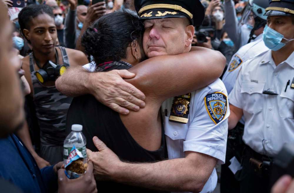Craig Ruttle / Associated Press files
Chief of Department of the New York City Police, Terence Monahan, hugs an activist as protesters paused while walking in New York, Monday.