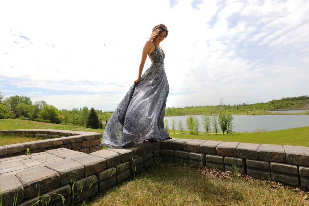 Reagan Hofer, a River East Collegiate graduated, poses in her dress at the family’s home. She plans to attend U of M in the fall. (Ruth Bonneville / Winnipeg Free Press)