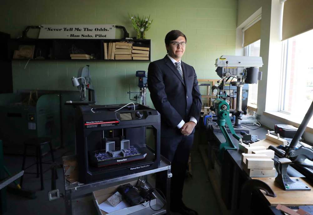 Grade 12 West Kildonan Collegiate student Ethan Sinclair poses in his grad suit in the school’s science lab.  (Ruth Bonneville / Winnipeg Free Press)