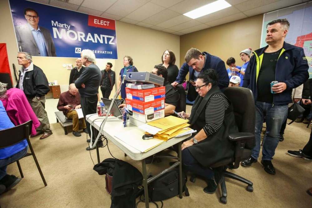 Marty Morantz's campaign manager Michael Kowalson (centre, leaning on chairs) watches results come in last year. (Mike Deal / Winnipeg Free Press files)