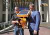 RUTH BONNEVILLE / WINNIPEG FREE PRESS Chuck Lewis of Expert Electric (left) & Councillor Kevin Klein outside city hall with one of Lewis' amber flashing lights.