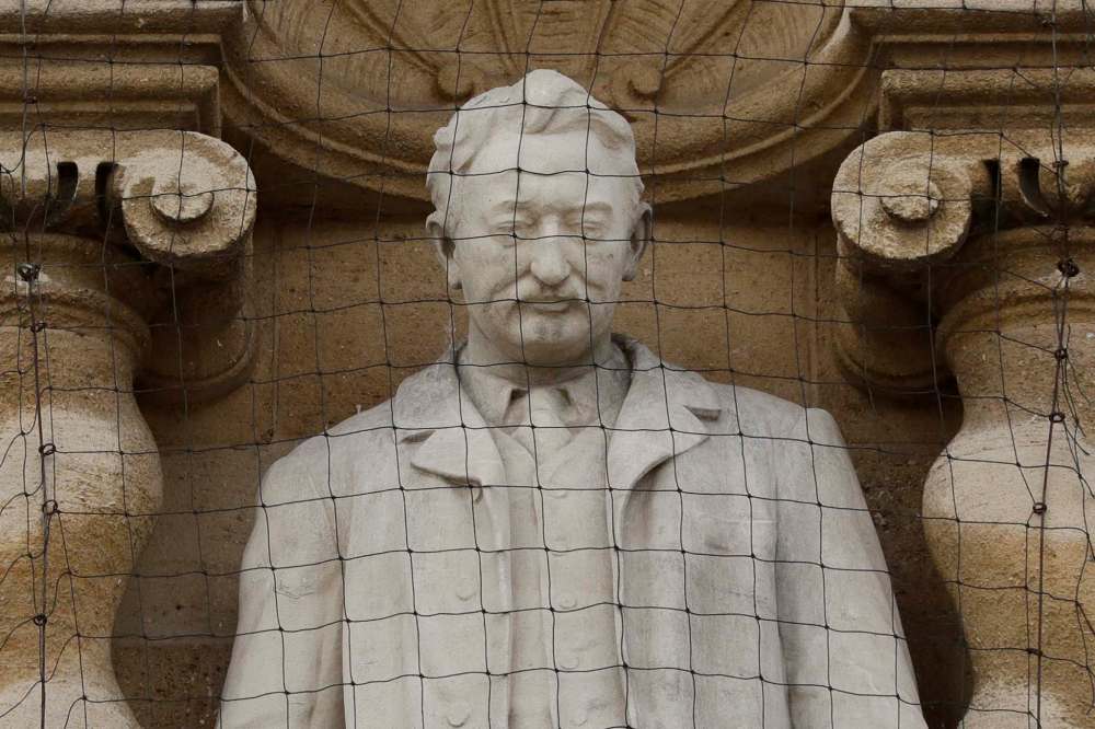 There is a movement afoot to get a statue of Cecil Rhodes removed from the facade of Oriel College in Oxford, England. (Matt Dunham / The Associated Press)