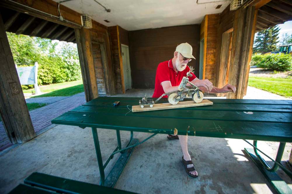 Leullier installs one of his reindeer at Grant’s Old Mill park. He encourages others to share their art, crafts and music in public spaces. (Mikaela MacKenzie / Winnipeg Free Press)