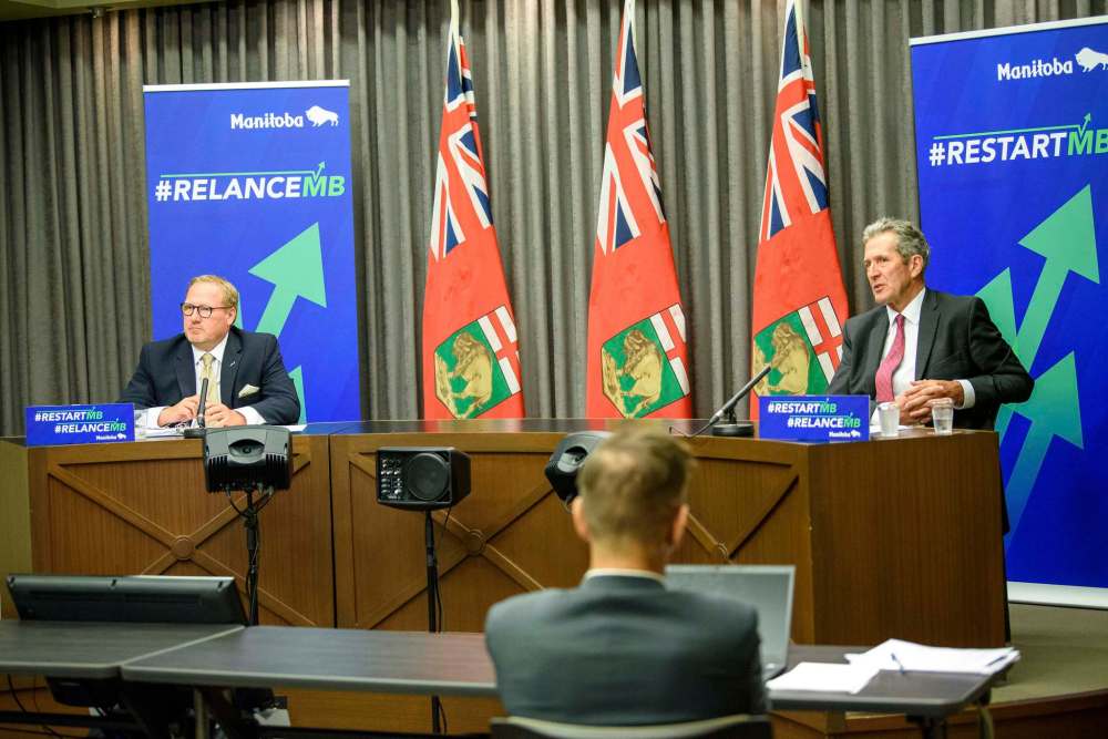 Premier Brian Pallister (right) and Finance Minister Scott Fielding said if the province stays on course with its positive pandemic recovery, they're expecting a $2.9 billion deficit. (Jesse Boily / Winnipeg Free Press)