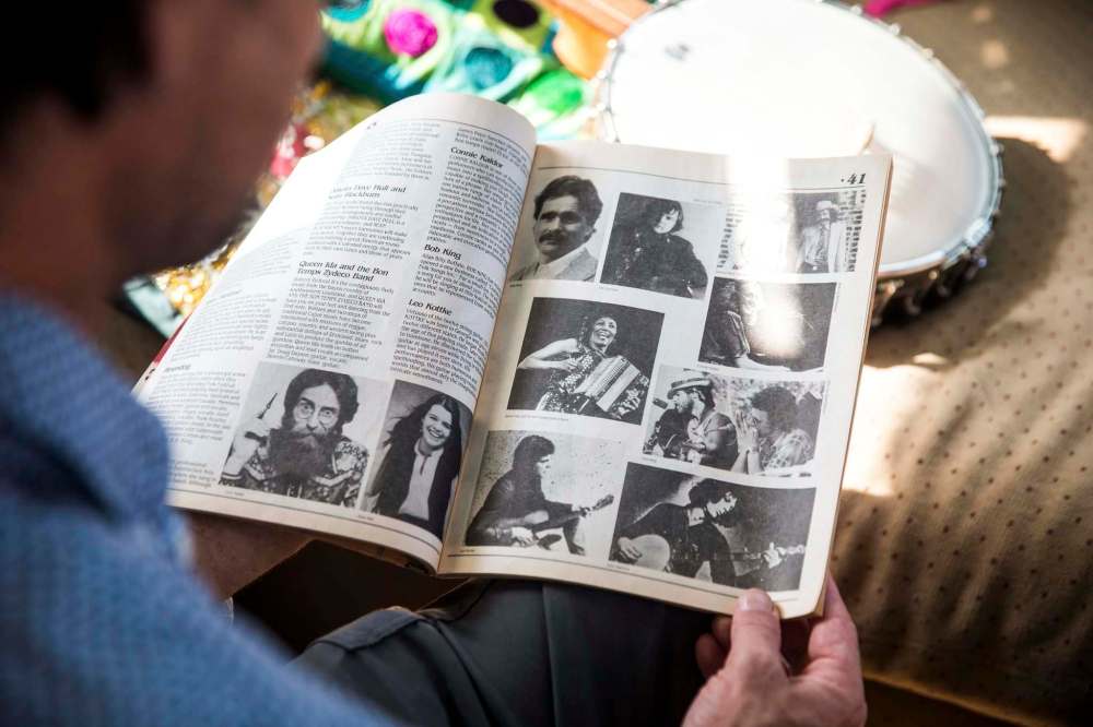 MIKAELA MACKENZIE / WINNIPEG FREE PRESS
Leonard Podolak, son of Folk Fest founder Mitch Podolak, poses for a portrait with a 1983 program in his house in Winnipeg on Wednesday, July 8, 2020. For Al Small story.Winnipeg Free Press 2020.