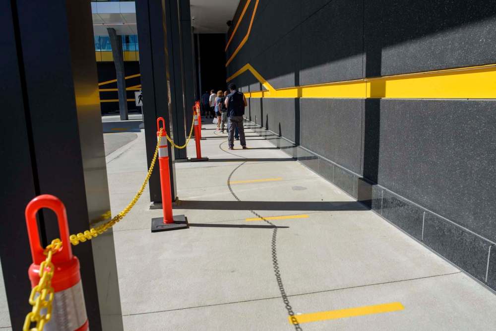 Markers on the ground ensured people waiting to get in were properly spaced apart. (Jesse Boily / Winnipeg Free Press)