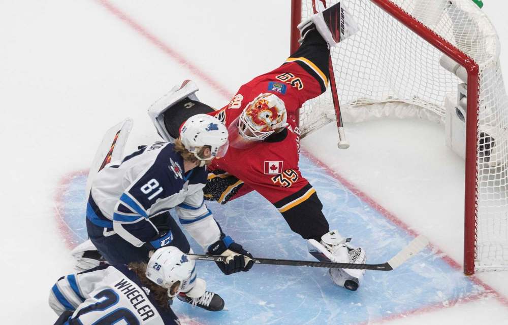 Jason Franson / The Canadian Press
Kyle Connor is stopped by goalie Cam Talbot Monday.