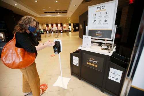 JOHN WOODS / WINNIPEG FREE PRESS
Hand sanitizer greets Alison Gillmor as she heads to a movie at Grant Park.