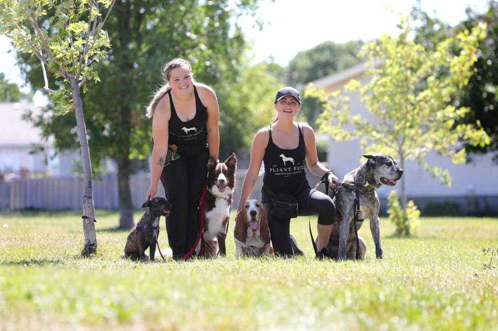 RUTH BONNEVILLE / WINNIPEG FREE PRESS
Emily Lowes, left, with dog training co-owner Leesa Westwood — along with four of their pet pupils.