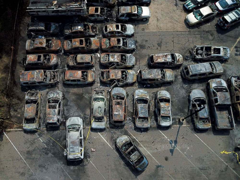 Morry Gash / The Associated Press
Burned out vehicles are seen Monday, Aug. 24, 2020, in Kenosha, Wis. Many of the cars were set on fire during protests Sunday night after a police shooting in the city.