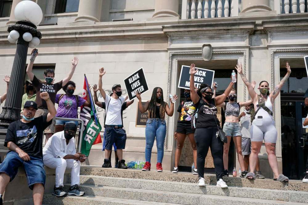 Morry Gash / The Associated Press
A small group of Black Lives Matter protesters hold a rally on the steps of the Kenosha County courthouse Monday, Aug. 24, 2020, in Kenosha, Wis. Kenosha police shot a man Sunday evening, setting off unrest in the city after a video appeared to show the officer firing several shots at close range into the man's back.