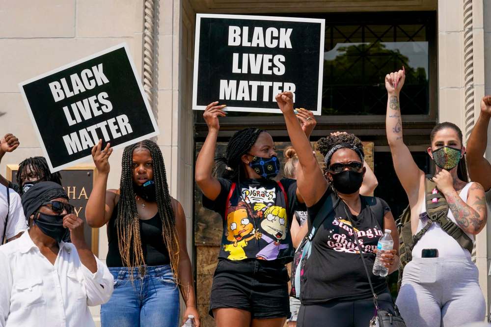Morry Gash / The Associated Press
A small group of Black Lives Matter protesters hold a rally on the steps of the Kenosha County courthouse Monday, Aug. 24, 2020, in Kenosha, Wis. Kenosha police shot a man Sunday evening, setting off unrest in the city after a video appeared to show the officer firing several shots at close range into the man's back.