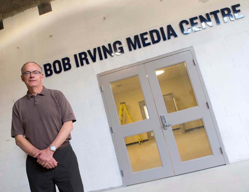 Irving stands in front of the doors leading into the Bob Irving Media Centre, which was named after the long-time broadcaster when Winnipeg's new stadium opened in 2013.