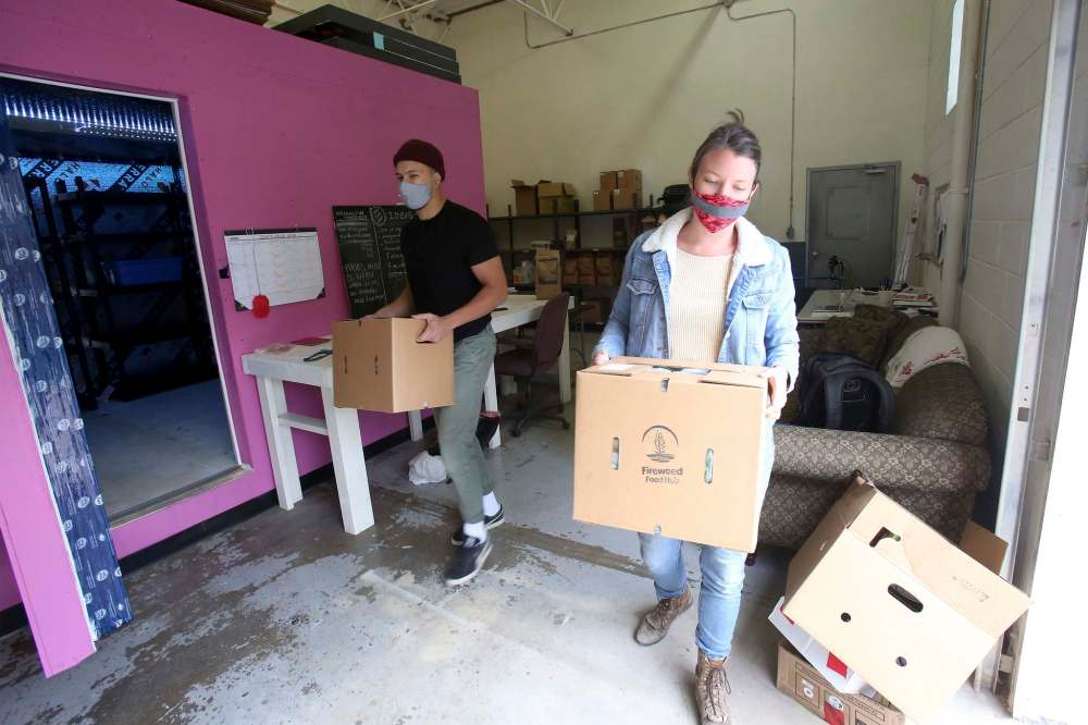 Anna Sigrithur and Conor Nedelec at the Fireweed Food Co-Op's food hub's warehouse on Clifton Street. (Shannon VanRaes / Winnipeg Free Press)