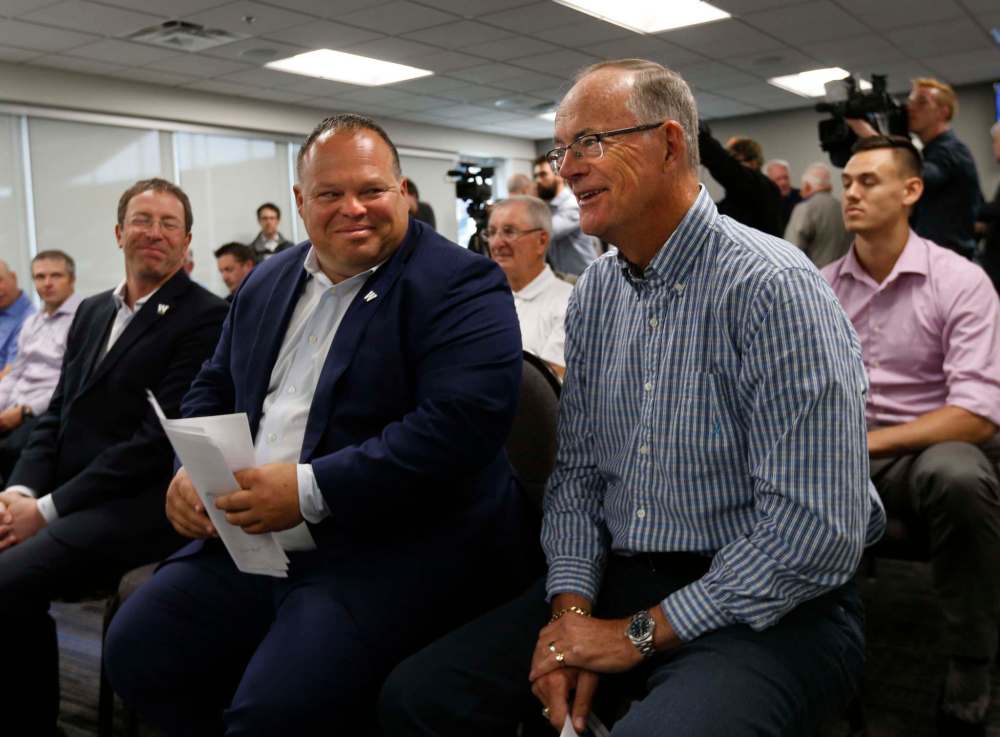 WAYNE GLOWACKI / WINNIPEG FREE PRESS files
President & CEO of the Winnipeg Football Club, Wade Miller, left, and Bob Irving listen to the announcement that Irving will be inducted into the Blue Bombers Hall of Fame in 2016.