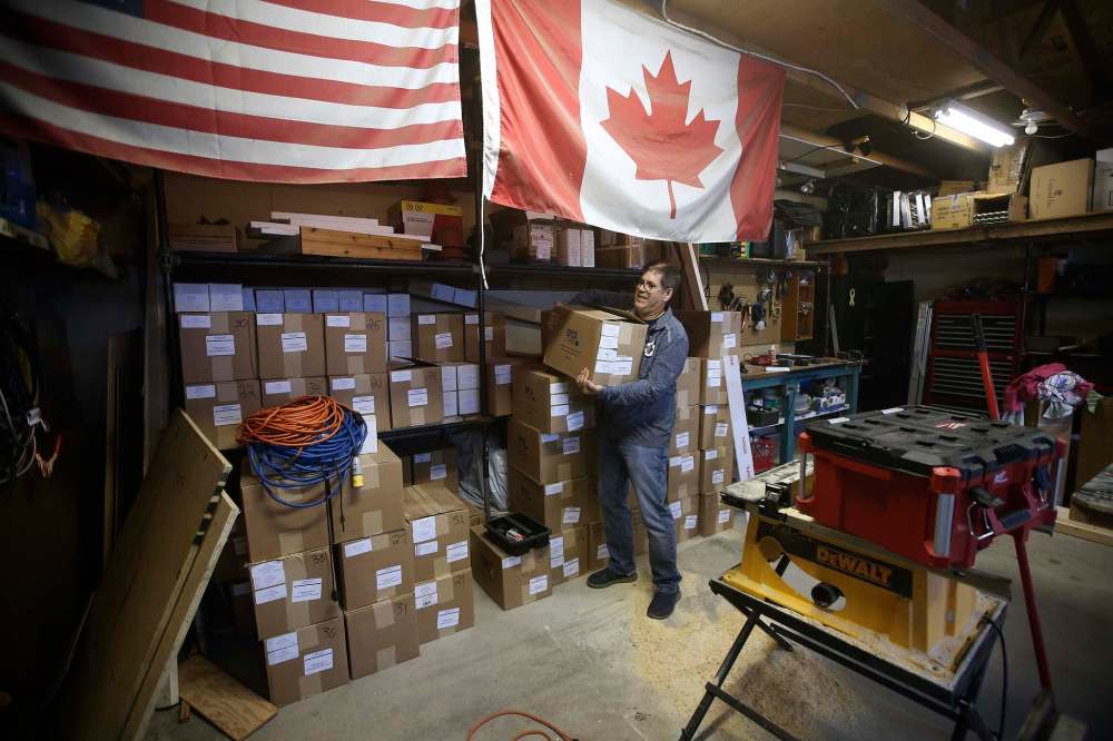 JOHN WOODS / WINNIPEG FREE PRESS
Edward Dubinsky grabs a box of bowling balls in the storage area at their office.