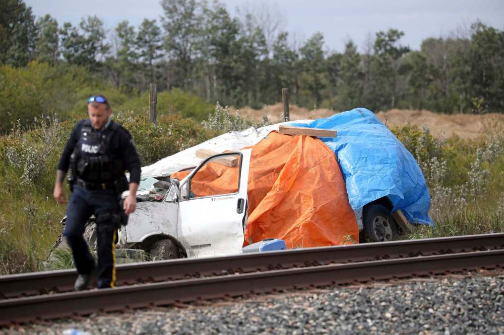 A passenger van sits next to the CP tracks east of Strathclair after a collision with a train on Tuesday afternoon. (Tim Smith/The Brandon Sun)