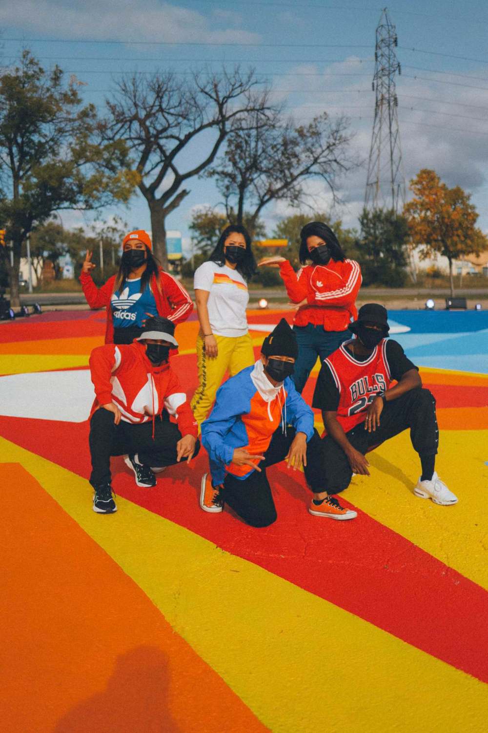 BNB Studios photo
Participants with the youth hip-hop mentorship program pose on a mural by artist Peatr Thomas.