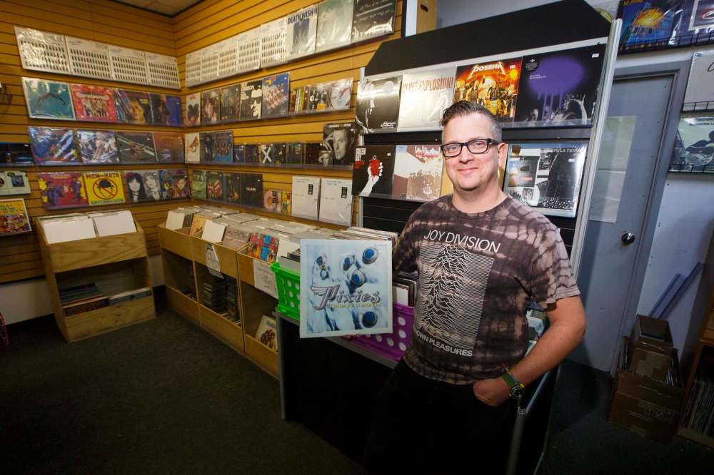 Planet of Sound owner Dave Wright holds the Pixies album Trompe le Monde that has the Henderson Highway store’s namesake song on it. Wright says ‘vinyl is definitely on the upswing and has been for a while.’ (Mike Deal / Winnipeg Free Press)