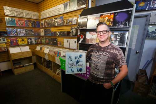 Planet of Sound owner Dave Wright holds the Pixies album Trompe le Monde that has the Henderson Highway store&rsquo;s namesake song on it. Wright says ‘vinyl is definitely on the upswing and has been for a while.&rsquo; (Mike Deal / Winnipeg Free Press)