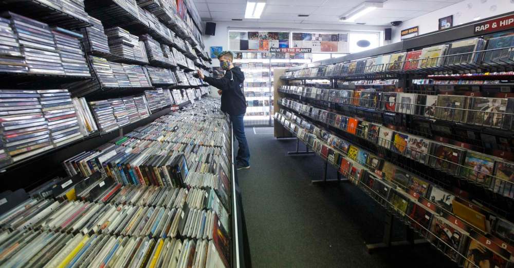 Store manager Cathie Stankey organizes some CDs. (Mike Deal / Winnipeg Free Press)