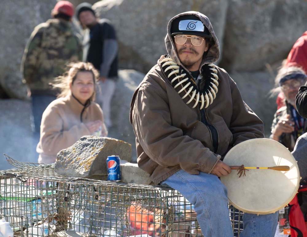 Photos by Mark O’Neill / The Canadian Press
A Sipekne’katik First Nation community member holds a drum as he sits on lobster traps in Saulnierville, N.S. on Sunday.
