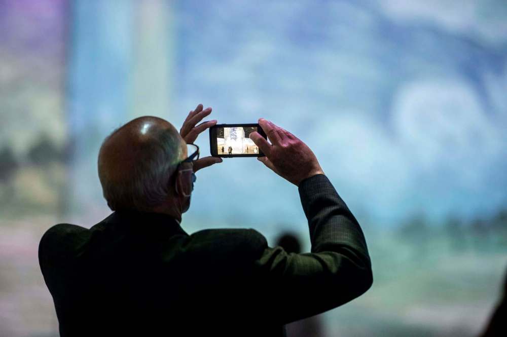 Mike Sudoma / Winnipeg Free PressPresident and CEO of Tourism Manitoba, Colin Ferguson, takes a photo with his phone as he takes in the works of Vincent Van Gogh as the Imagine Van Gogh, The Immersive Exhibition is open to the public for the first time at the RBC Convention Centre during a media event Thursday afternoonSeptember 23, 2020