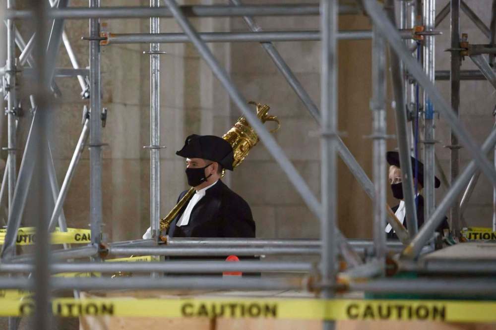 MIKE DEAL / WINNIPEG FREE PRESSThe Mace carried by Dave Shuttleworth the Sergeant-at-Arms followed by Speaker of the Legislative Assembly, Myrna Driedger, pass beneath scaffolding in the rotunda as they head towards the Assembly chambers for the Speech from the throne Wednesday afternoon.201007 - Wednesday, October 07, 2020.