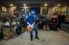 Alan Ollinger plays the bass guitar he bought from Streetheart co-founder Spider in his backyard man-cave, a 600-square-foot building that contains scores of musical memorabilia he’s collected thru the years.