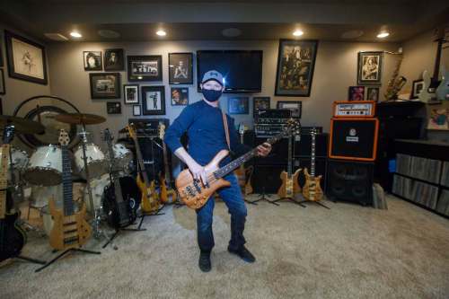 Alan Ollinger plays the bass guitar he bought from Streetheart co-founder Spider in his backyard man-cave, a 600-square-foot building that contains scores of musical memorabilia he&rsquo;s collected thru the years.
