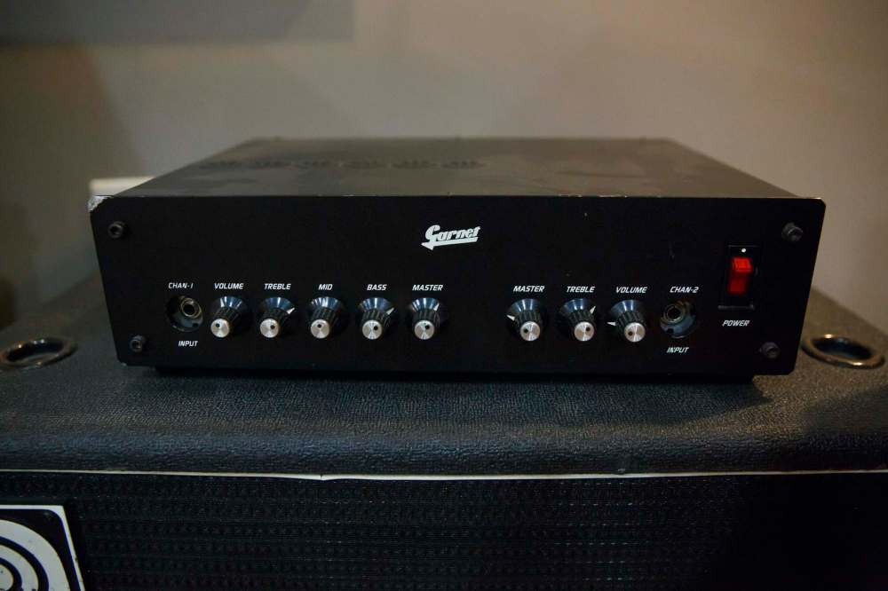 One-of-a-kind Garnet pre-amp built in mid-80s that was ahead of its time in size and power sits amongst Alan's collection of larger amps.