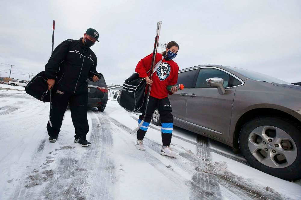 JOHN WOODS / WINNIPEG FREE PRESS
Shaun Chornley, president of the St Boniface Minor Hockey Association, and his daughter Payton enter Maginot Arena for a practice.