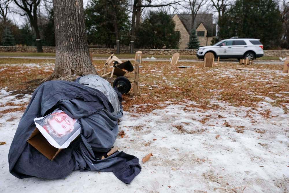 Daniel Crump / Winnipeg Free Press. An effigy of Manitoba Premier Brian Pallister dressed as the grim reaper lays toppled on the Wellington Crescent foot path in front of the premiers home. The mock graveyard has been set up in protest over the provincial governments handling of the coronavirus pandemic. October 31, 2020.
