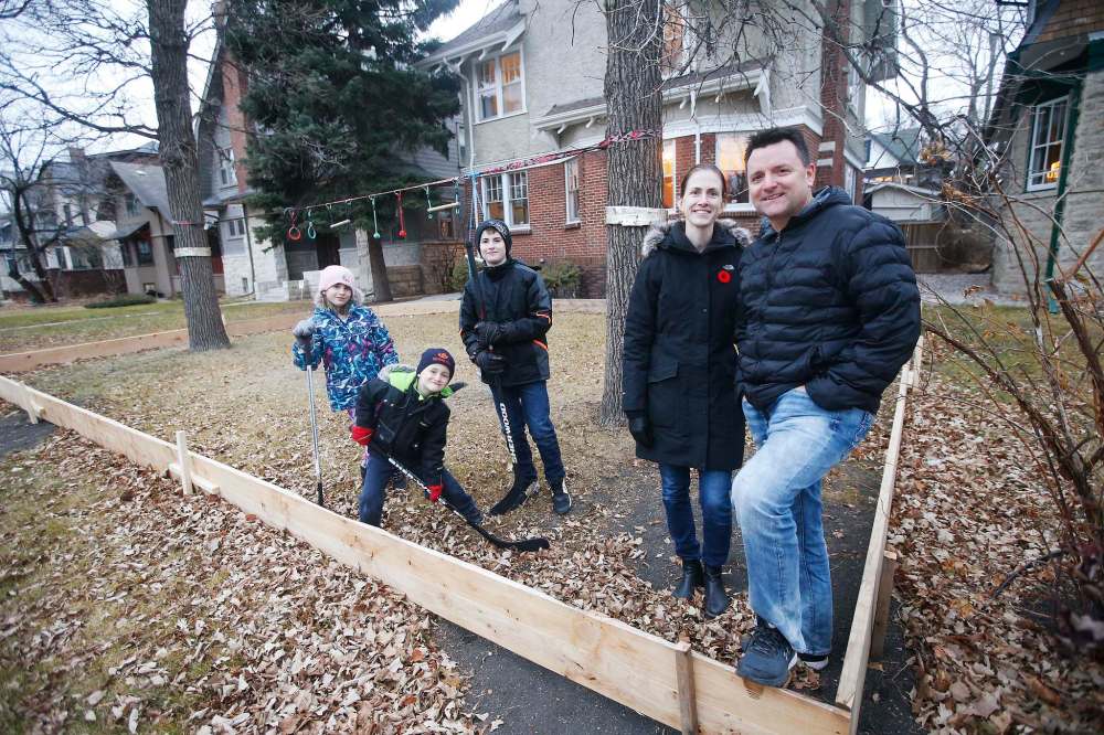 JOHN WOODS / WINNIPEG FREE PRESS
Shane and Kara McCartney are building a rink for their children (from left) Emerson, Blake and Aiden at their Crescentwood home.