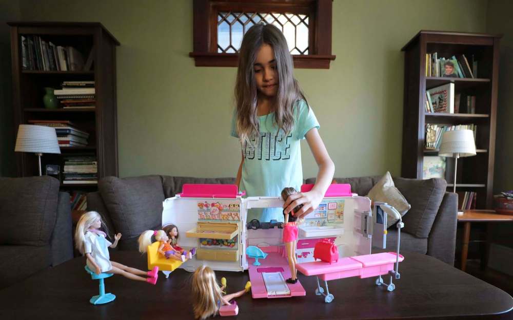 RUTH BONNEVILLE / WINNIPEG FREE PRESS
Anna Milne-Karn plays with her pink Barbie mobile clinic toy after school.