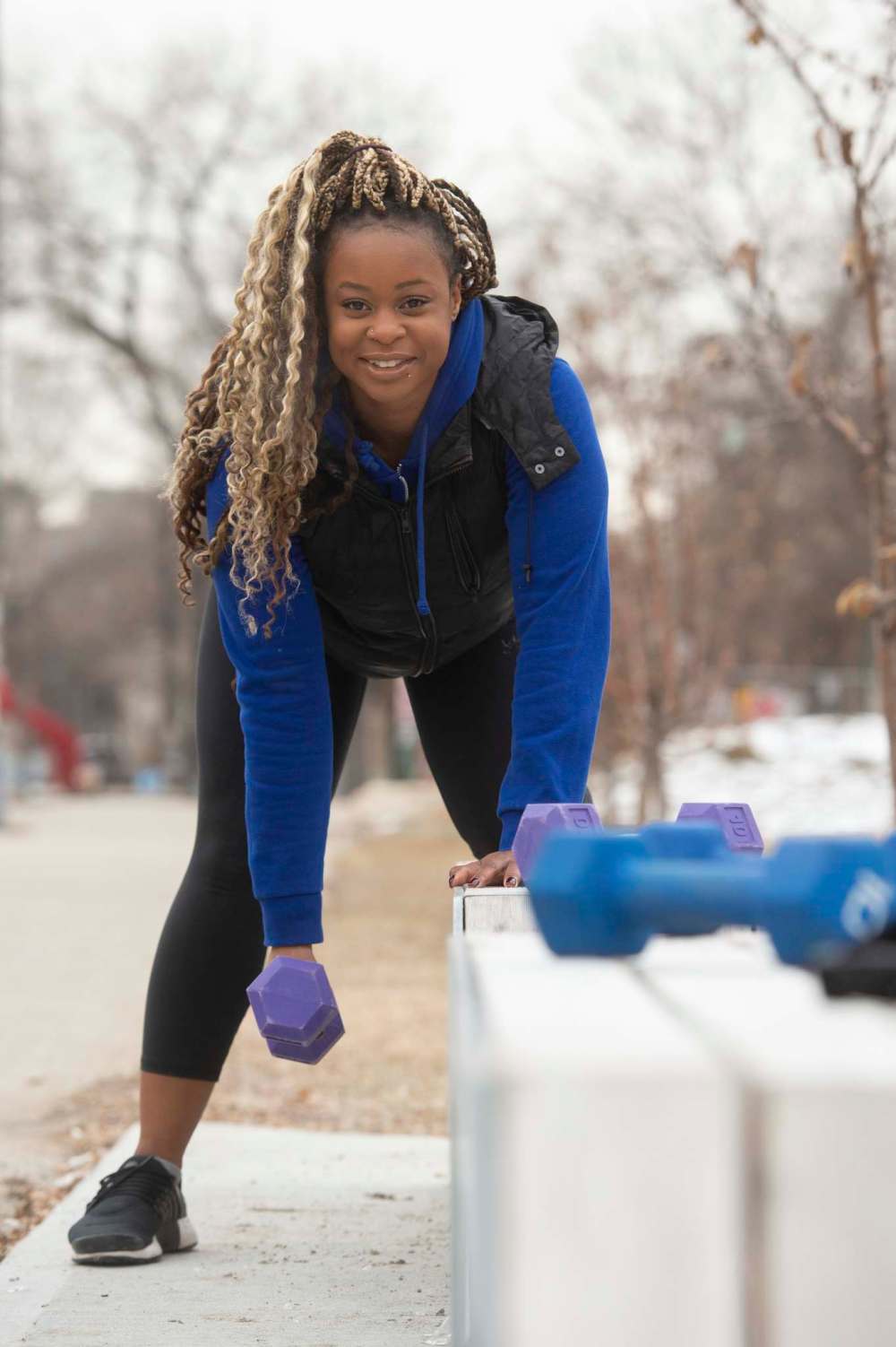 Fitness trainer Chinwe Asagwara shows off some easy to do home exercises using only a bench and two 10 pound dumbbells. (Mike Sudoma / Winnipeg Free Press)