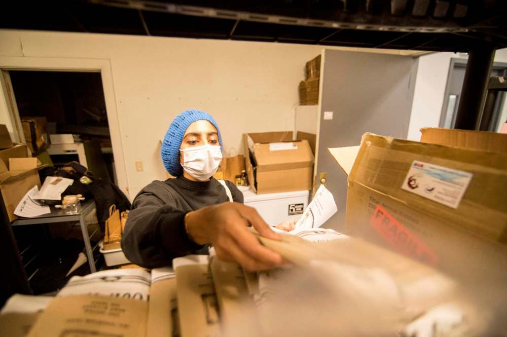 Mike Sudoma / Winnipeg Free Press
Farzana Esmail sorts through local Winnipeg products to fulfill an order through new local business network, Good Local Friday.
