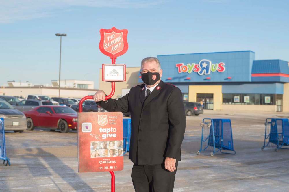 Maj. Jamie Rands with one of the Salvations Army's new tiptap machines that are replacing the red kettle bells Winnipeggers are used to seeing every Christmas. The wireless devices have a pre-set $5 donation for a single tap. (Mike Sudoma / Winnipeg Free Press)