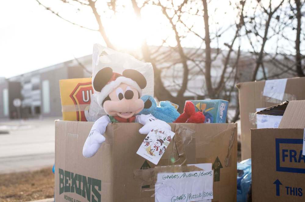 A stuffed Mickey Mouse doll sticks out of a box of toy donations for the Salvation Army’s Toy Mountain drive in the Toys’ R Us parking lot on Friday. (Mike Sudoma / Winnipeg Free Press)
