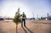 MIKAELA MACKENZIE / WINNIPEG FREE PRESS Ray DuBois, owner of Ron Paul Garden Centre, poses for a portrait with a pre-sold tree in the empty space where the Christmas tree lot used to be in Winnipeg on Monday, Dec. 7, 2020.
