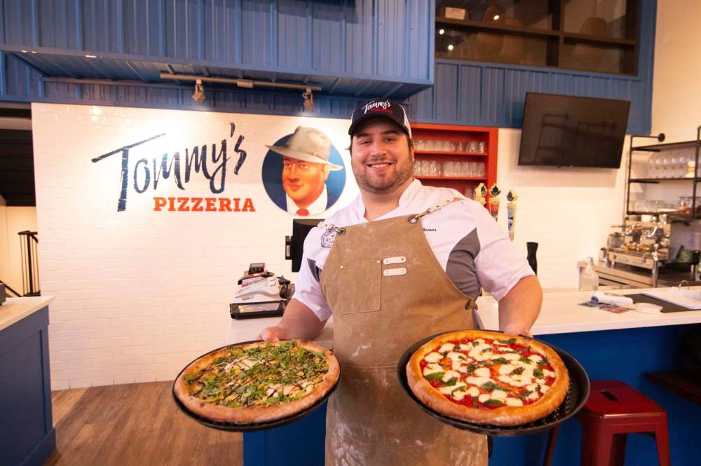 Tommy’s Pizzeria co-owner Thomas Schneider with a pair of pizzas — the Audrey Mayer (left, truffle mushroom) and the Nick Bean (margherita). (Mike Sudoma / Winnipeg Free Press)