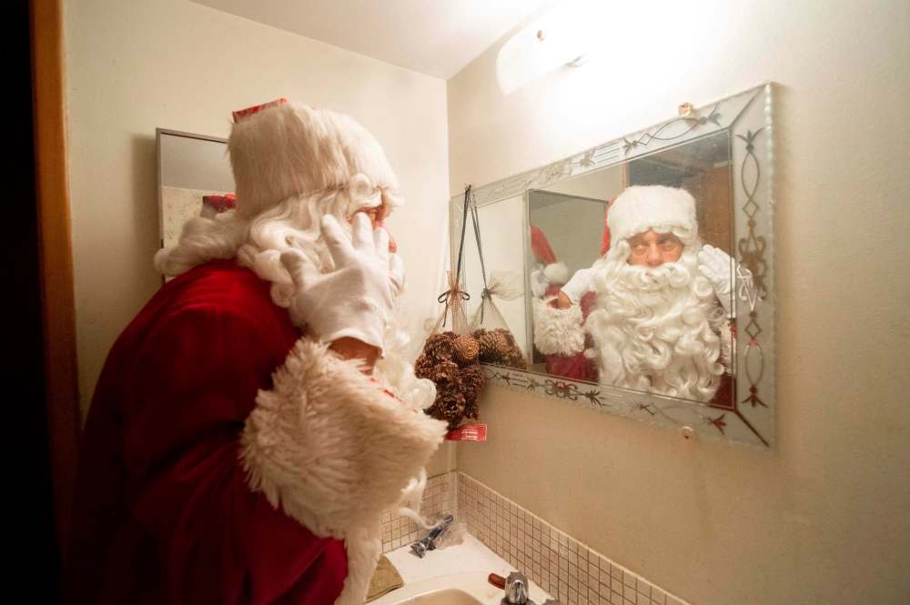 Stan Bedernjak gets his beard and hat ready to head out to spread some Christmas cheer last week.